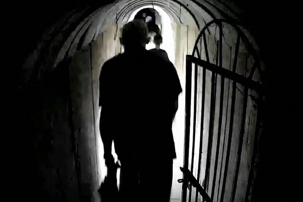 Image shows what the Israeli army says is Hamas’ chief in Gaza, Yahya Sinwar, walking in a tunnel along with other people. Photo: Israeli Army via AFP