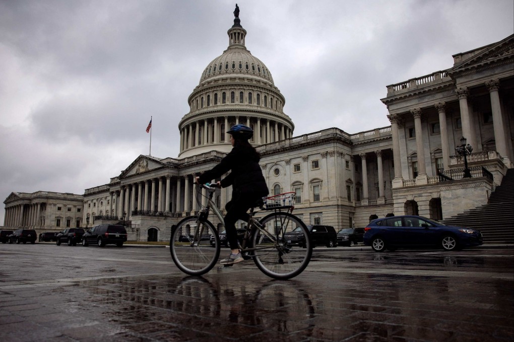 A woman rides a bicycle past the US Capitol building on Sunday. Photo: AFP