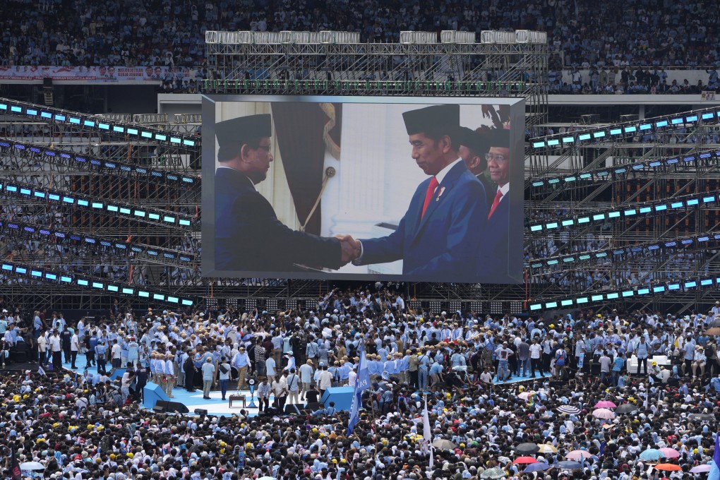 A photo of Indonesian President Joko Widodo (right) shaking hands with presidential elect Prabowo Subianto is displayed on a large screen during Subianto’s campaign rally at Gelora Bung Karno Main Stadium in Jakarta on February 10. Photo: AP