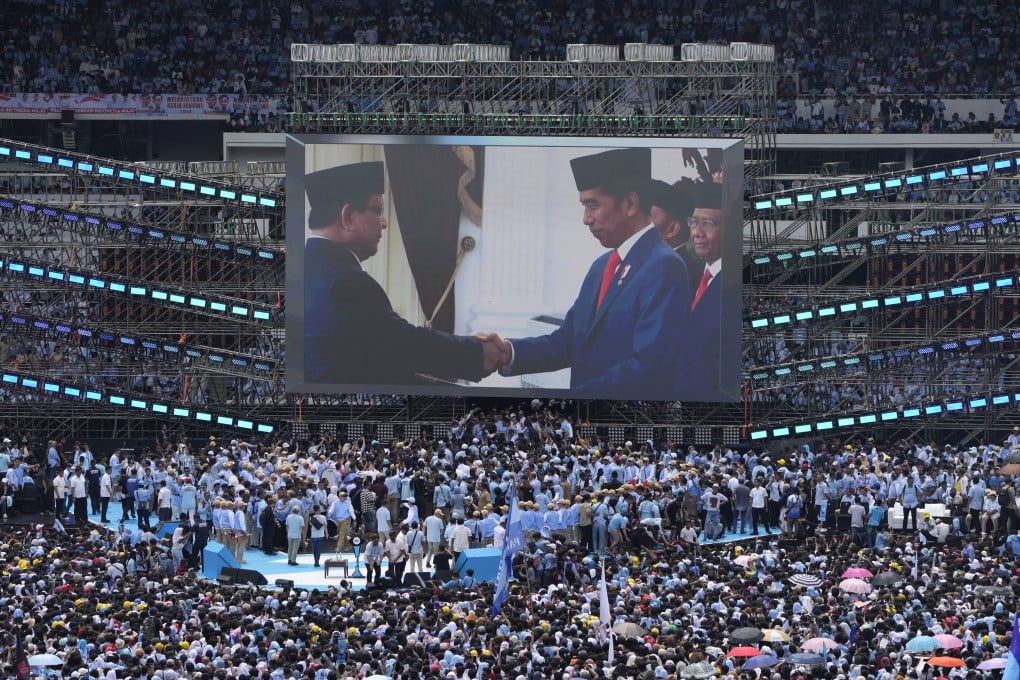 A photo of Indonesian President Joko Widodo (right) shaking hands with presidential elect Prabowo Subianto is displayed on a large screen during Subianto’s campaign rally at Gelora Bung Karno Main Stadium in Jakarta on February 10. Photo: AP