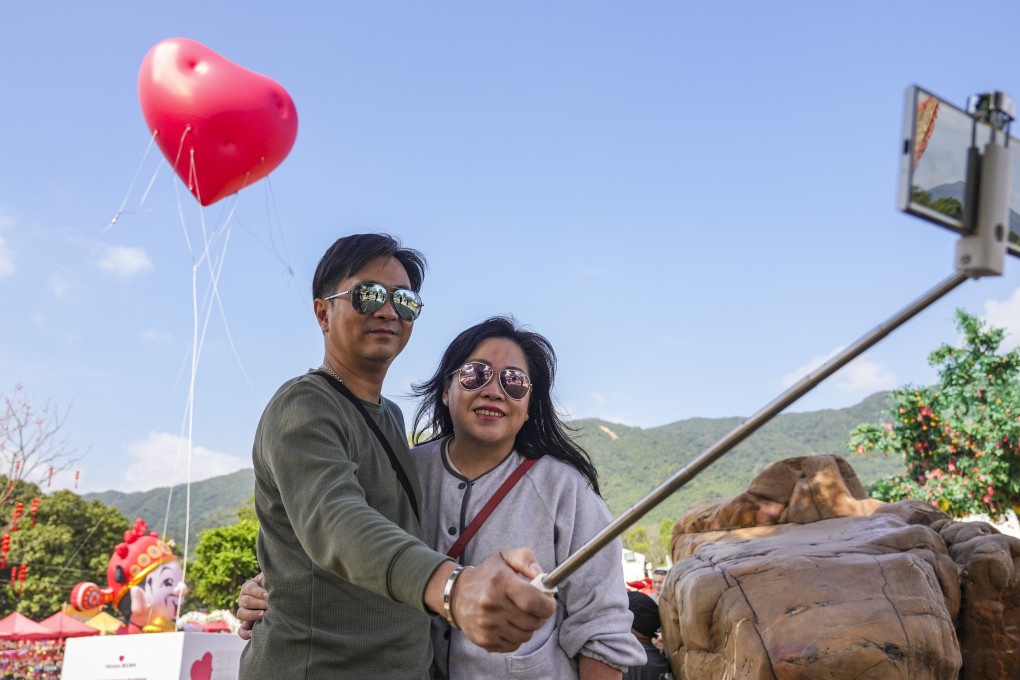A couple takes selfies in front of a “Chubby Hearts” art installation by fashion designer Anya Hindmarch in Lam Tsuen, Tai Po, on Valentine’s day. Photo: Eugene Lee