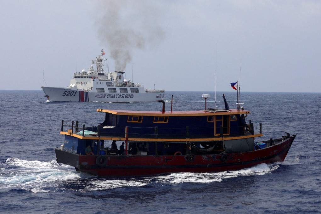 A Philippine supply boat sails near a Chinese Coast Guard ship during a resupply mission for Filipino troops stationed at a grounded warship in the South China Sea. Photo: Reuters