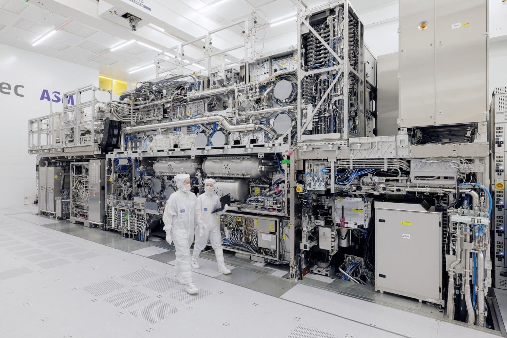 ASML engineers walk past an EUV tool at the company’s headquarters in Veldhoven, Netherlands. Photo: Handout