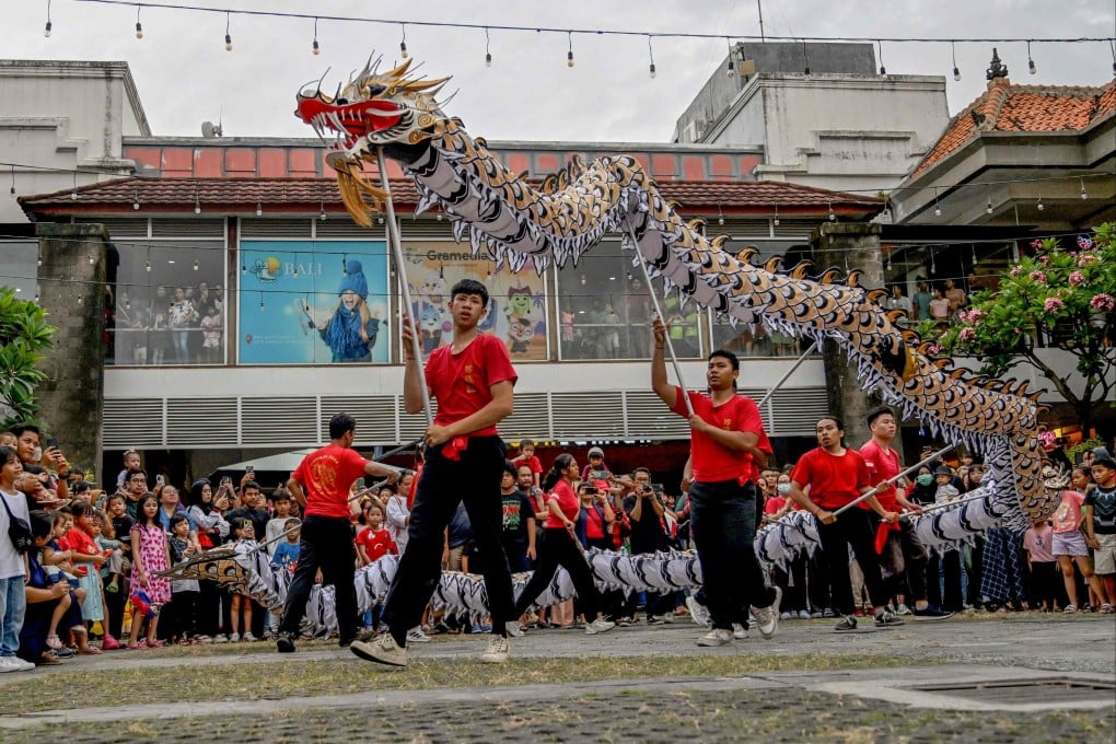 Performers stage a dragon dance to mark the first day of the Lunar New Year of the Dragon, in Denpasar, Bali, on Saturday. Photo: AFP