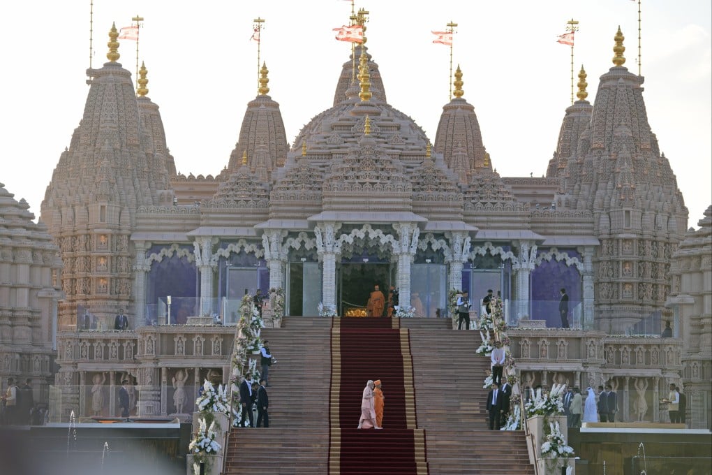 Indian Prime Minister Narendra Modi (left) walks across the carpeted steps with Hindu priest Brahmaviharidas Swami to inaugurate the first stone-built Hindu temple in the Middle East in Abu Mureikha, 40km northeast of Abu Dhabi, in the United Arab Emirates on Wednesday. Photo: AP