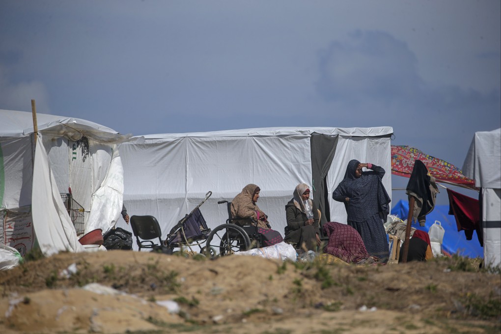 A Palestinian family displaced from Rafah sits outside a shelter in Deir Al Balah in the southern Gaza Strip on Wednesday. Photo: EPA-EFE