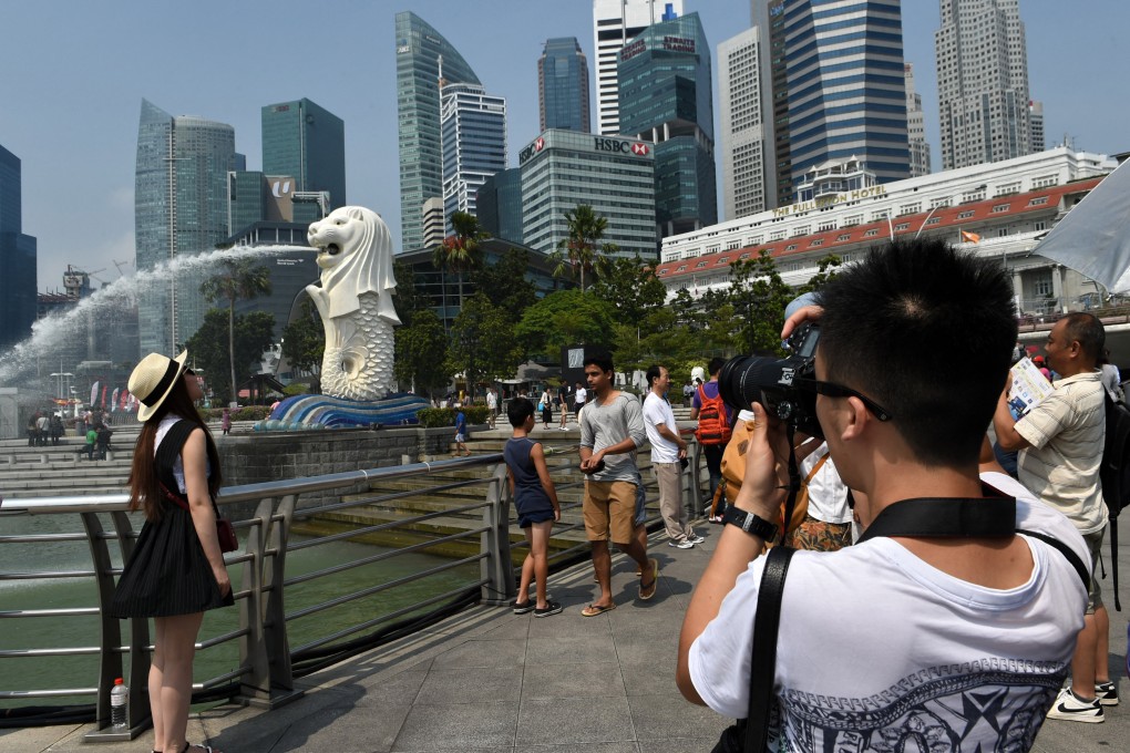 Chinese tourists visit the iconic Merlion statue in Singapore. Photo: AFP