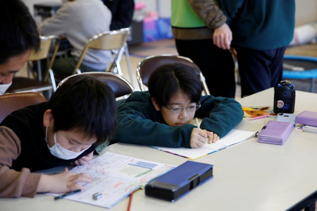 Children do their homework at a children’s play space open for survivors of the earthquake in Suzu. The government plans to boost annual spending on child care and bring it to 16 per cent of gross domestic product from 11 per cent. Photo: Reuters