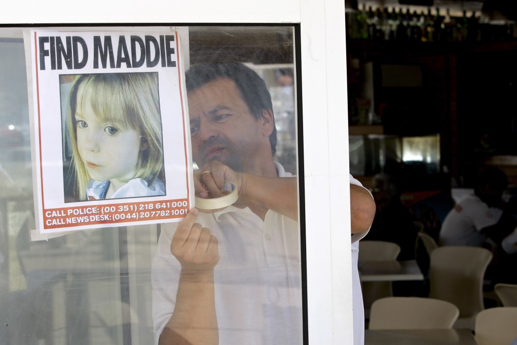 A waiter displays a picture of missing Madeleine McCann on a restaurant’s window in 2007, in Praia da Luz, southern Portugal. Photo: AP
