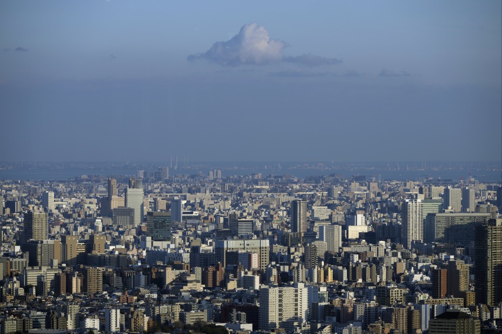 A cloud is seen over the Tokyo cityscape on February 8. Officials and analysts talking up the economy may have succeeded in projecting an image of renewed vigour, but many challenges remain. Photo: EPA-EFE