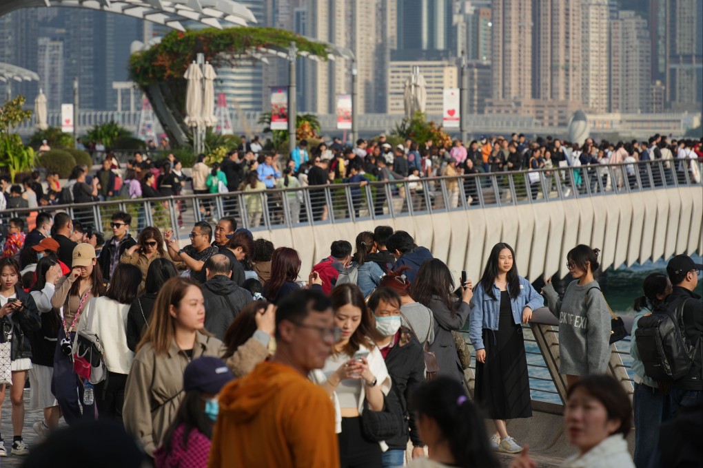 Visitors at the Tsim Sha Tsui waterfront. Chief Secretary Eric Chan said he hoped more tourists could visit Hong Kong from the mainland “as soon as possible.” Photo: Eugene Lee