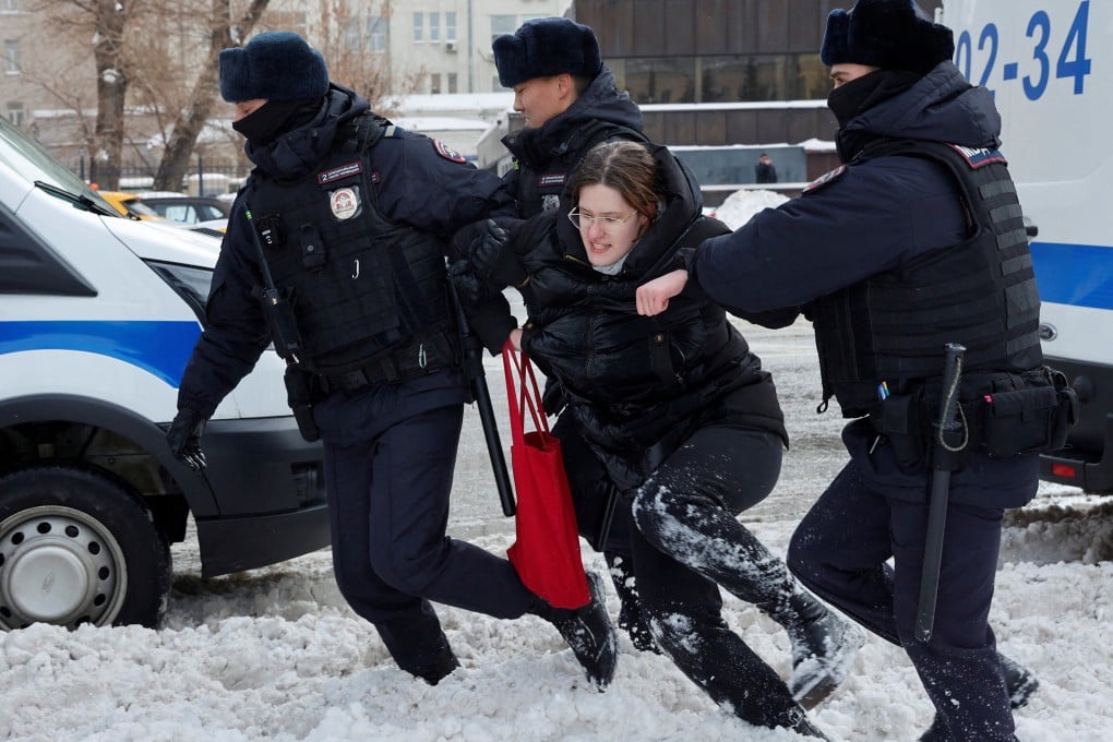 Police officers detain a woman during a gathering in memory of Russian opposition leader Alexei Navalny near the Wall of Grief monument in Moscow on Saturday. Photo: Reuters