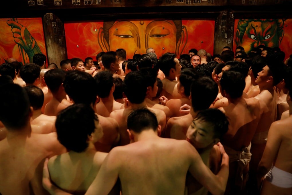 Men dressed in loincloths prepare to snatch a wooden stick called “shingi” tossed by the priest during a naked festival at Saidaiji Temple in Okayama, Okayama Prefecture Japan. Photo: Reuters