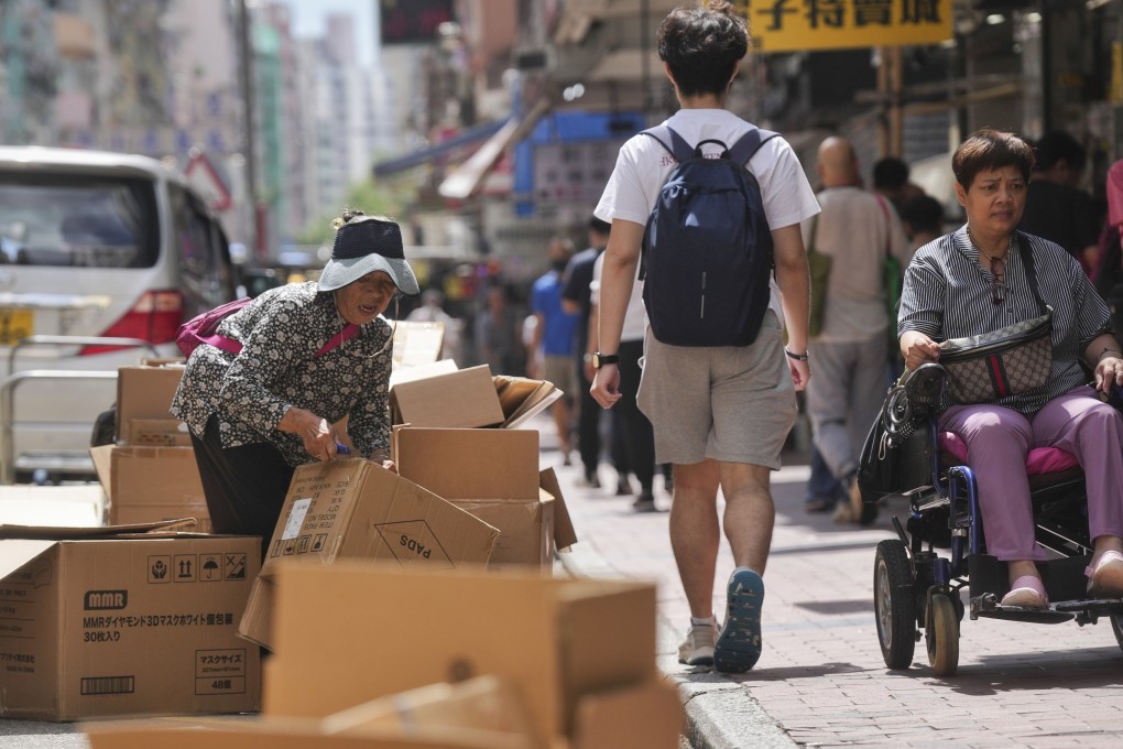 An elderly woman sorts out abandoned cardboard boxes for resale in Sham Shui Po. The city’s poverty rate in 2020 was 23.6 per cent, government statistics have shown – equivalent to 1.65 million people. Photo: Elson LI