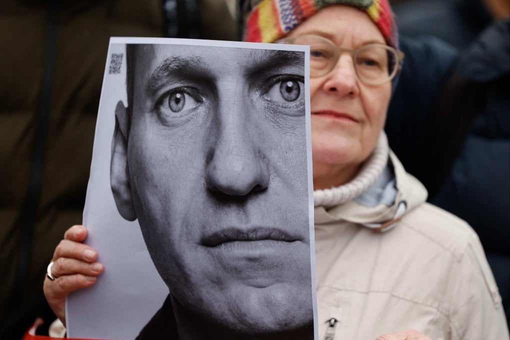 A woman holds a photo of Russian opposition leader Alexei Navalny at a memorial this month in front of the Russian embassy in Berlin, following Navalny’s death in an Arctic prison. Photo: AFP