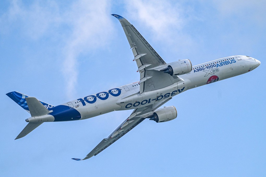 An Airbus A350-1000 flies during a preview of the Singapore Airshow on Sunday. All flights leaving the city state must depart with 1 per cent sustainable aviation fuel in their tanks from 2026, the government said on Monday. Photo: AFP