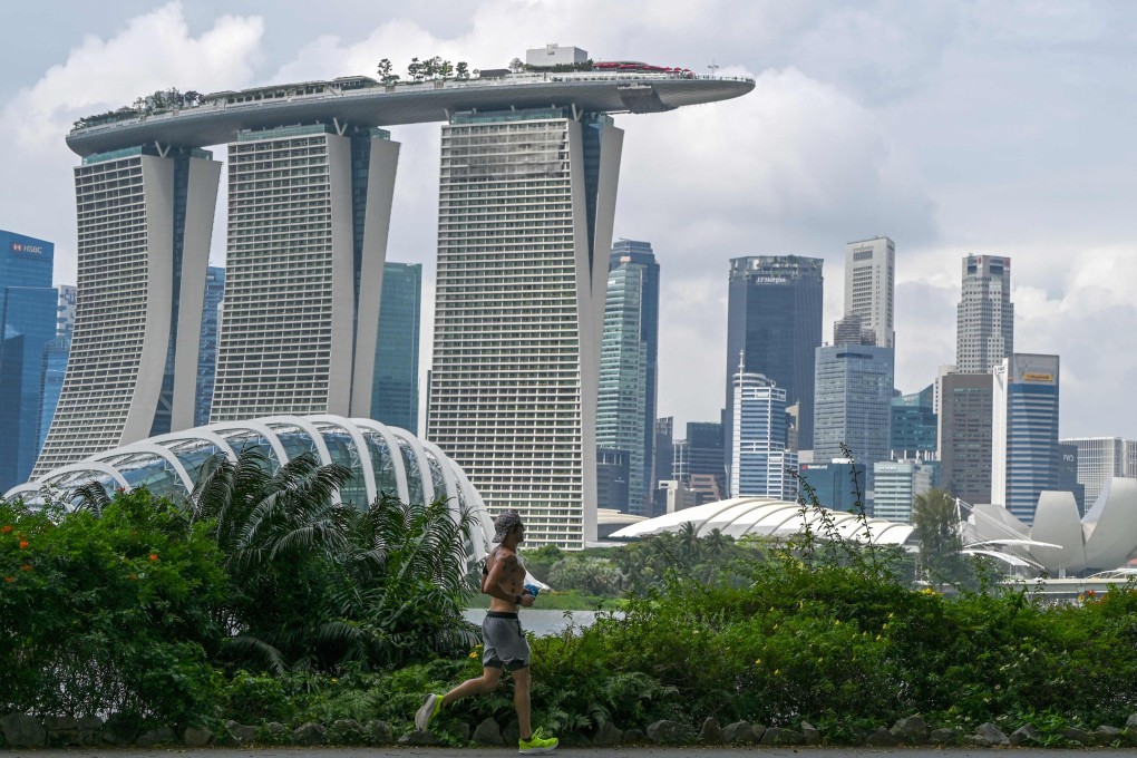 A man jogs along the Marina Bay East Park, past the Marina Bay Sands resort in Singapore. The number of shoplifting cases in Singapore increased again last year, making up the highest proportion of all reported physical crimes. Photo: AFP