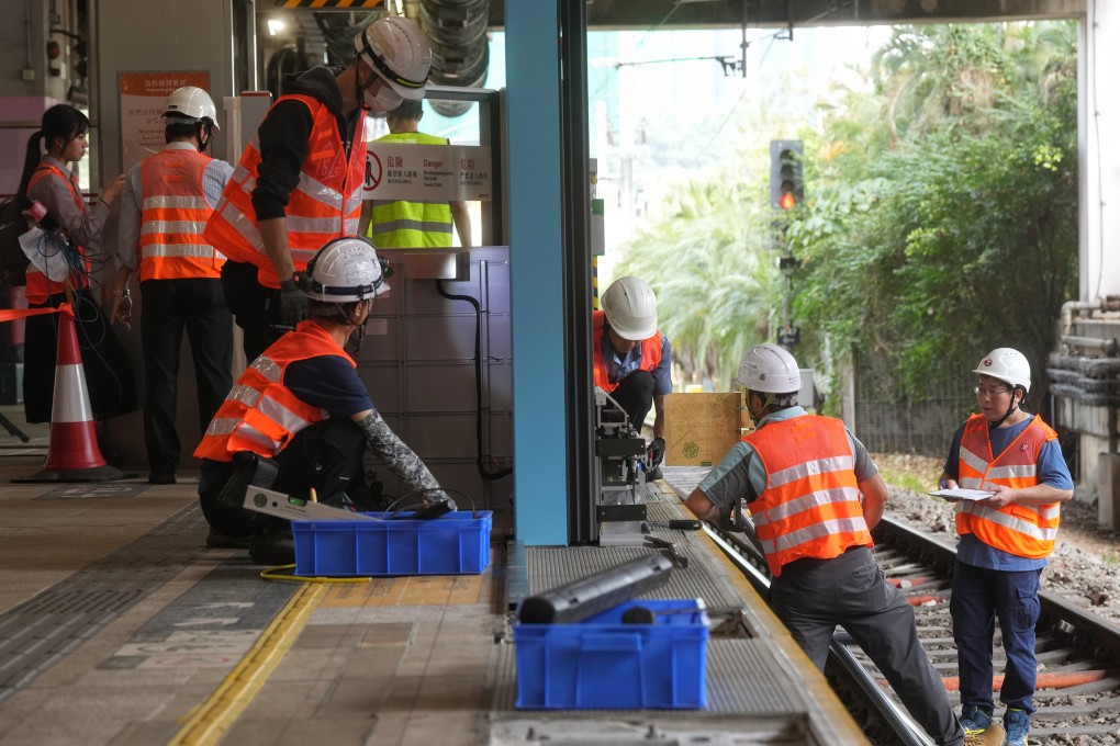 Workers test and install  automatic doors at Sha Tin station. The MTR Corp’s project aims to prevent incidents of people falling or jumping onto the tracks. Photo: Elson Li