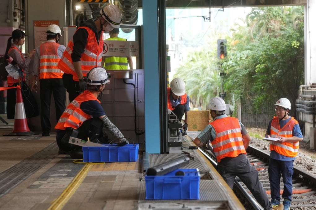 Workers test and install automatic doors at Sha Tin station. The MTR Corp’s project aims to prevent incidents of people falling or jumping onto the tracks. Photo: Elson Li