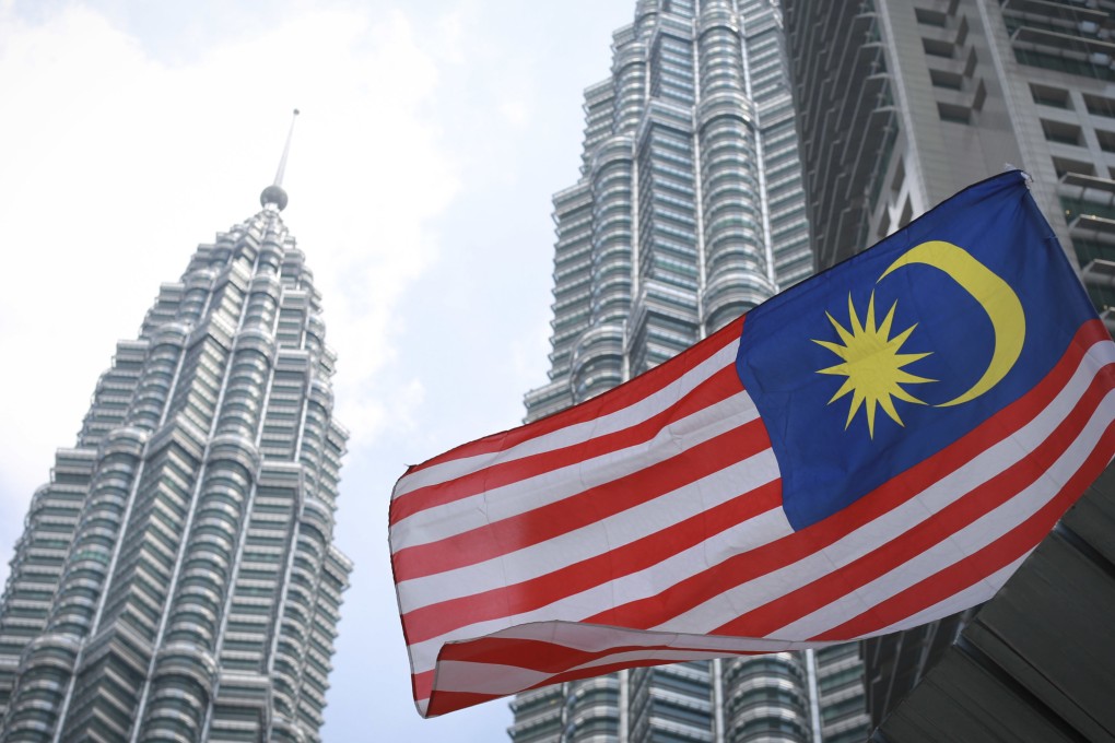 Malaysia’s national flag flies in front of its landmark Petronas Twin Towers in Kuala Lumpur. The nation’s central bank said Malaysia’s economic growth this year will be driven by improved external demand and strong domestic spending. Photo: AP