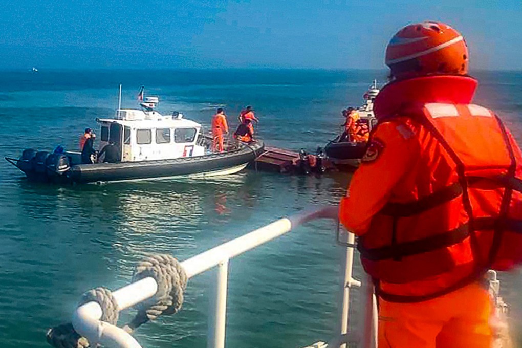 Taiwanese coast guards inspect a vessel that capsized during a chase off the coast of Kinmen archipelago on February 14. Photo: Taiwan Coast Guard Administration via AP