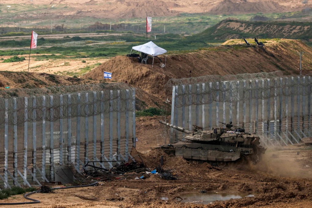 An Israeli battle tank crossing the border into northern Gaza on Monday. Photo: AFP