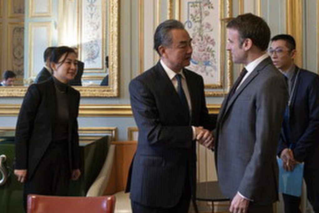 Chinese Foreign Minister Wang Yi (centre, left) shakes hands with French President Emmanuel Macron during talks in Paris on Tuesday. Photo: mfa.gov.cn