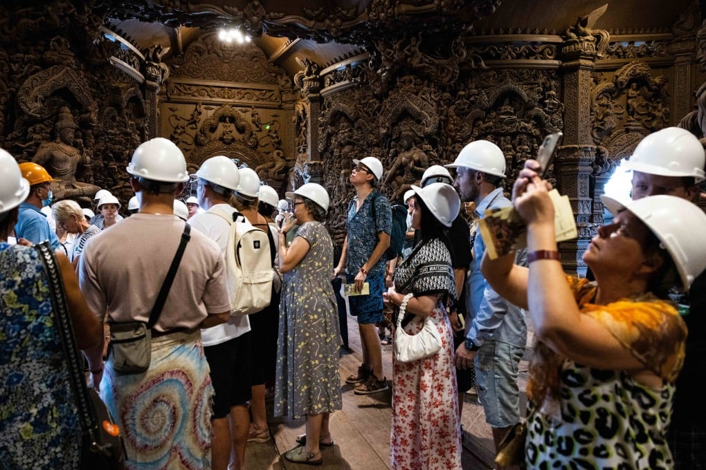 Tourists listen to a guided tour in Russian at the Sanctuary of Truth on September 24, 2023 in Pattaya, Thailand. In October, Thailand began automatically granting Russians stays of up to three months in the country – an increase from 30 days. Photo: Getty Images
