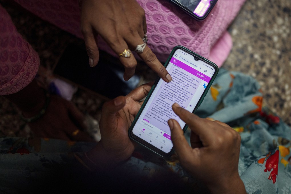 Women learn to use the Myna Bolo app that is powered by AI running on OpenAI’s ChatGPT model. Photo: AP