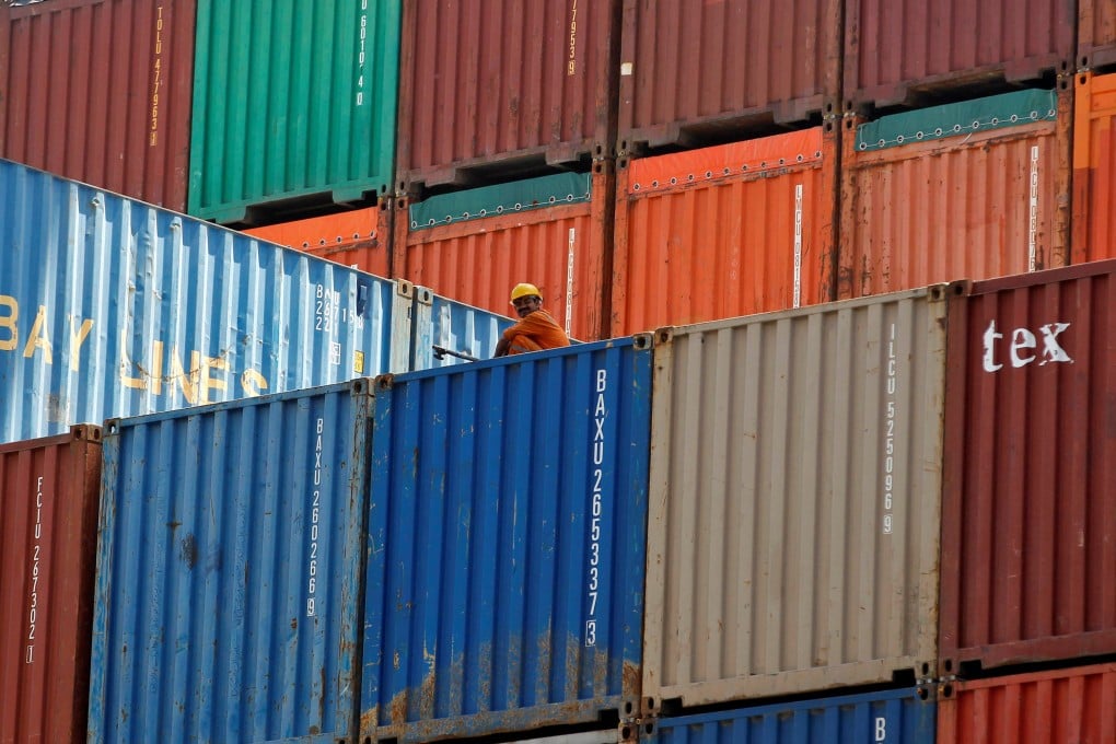 A worker sits on a ship carrying containers at Mundra port in the western Indian state of Gujarat. The European Union is mulling sanctions on Chinese and Indian firms’ export of electronics to Russia. Photo: Reuters