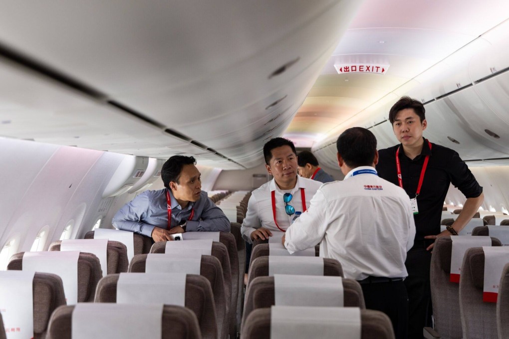 Singapore Airshow attendees explore the economy-class cabin of the Comac C919. Photo: Bloomberg
