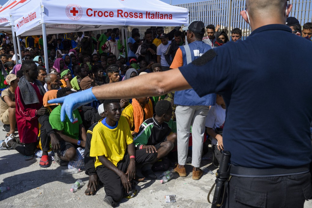 Migrants wait to be transferred from Lampedusa Island. Albania has agreed to host two migrant processing centres on its territory. Photo: AP