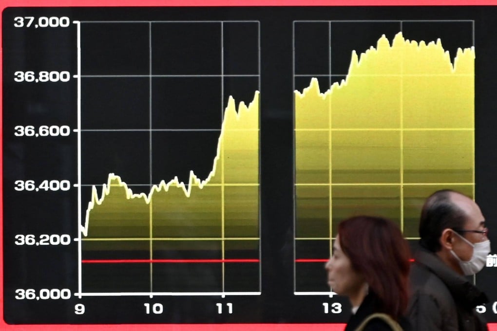 An electronic board displays the chart of daily share price movement on the Tokyo Stock Exchange along a street in Tokyo on February 8. Gains in tech shares have contributed to a surge in stock markets around the world, driven largely by the influence of the “Magnificent Seven” group of large tech firms. Photo: AFP