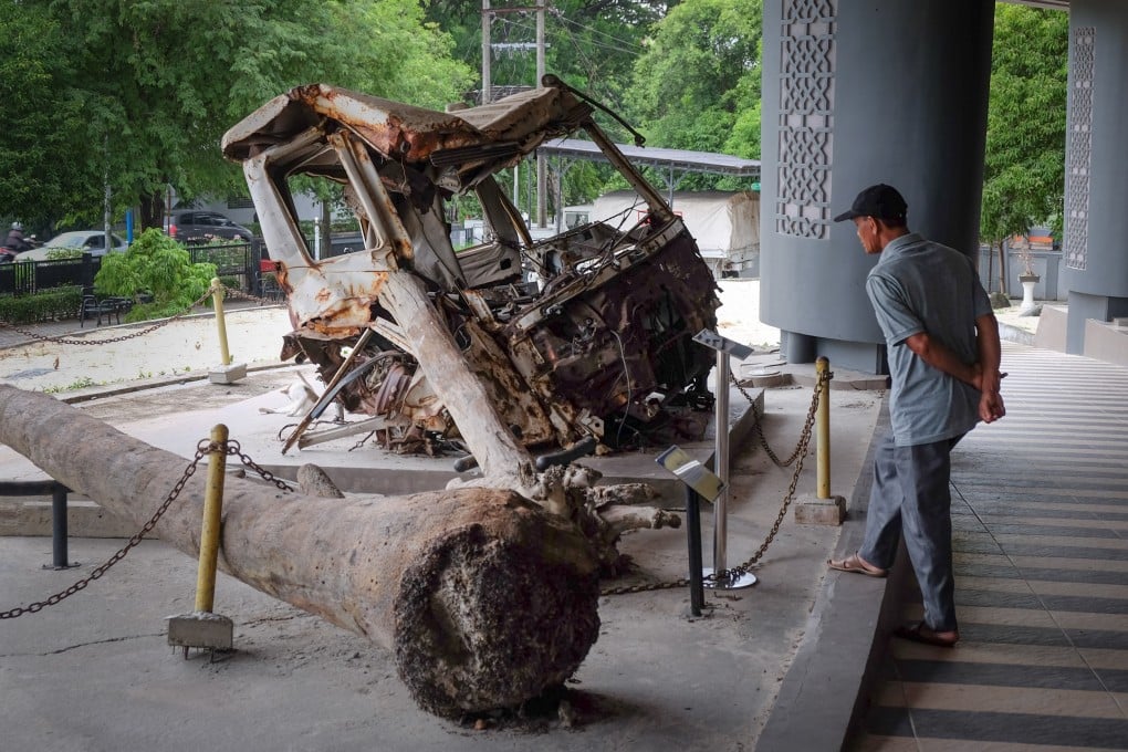 A man looks at the remains of a truck damaged during the 2004 Boxing Day Tsunami, in Aceh, Indonesia. Twenty years on, a visit to the Muslim-majority province affords stunning nature and some modern conveniences. Photo: Marco Ferrarese