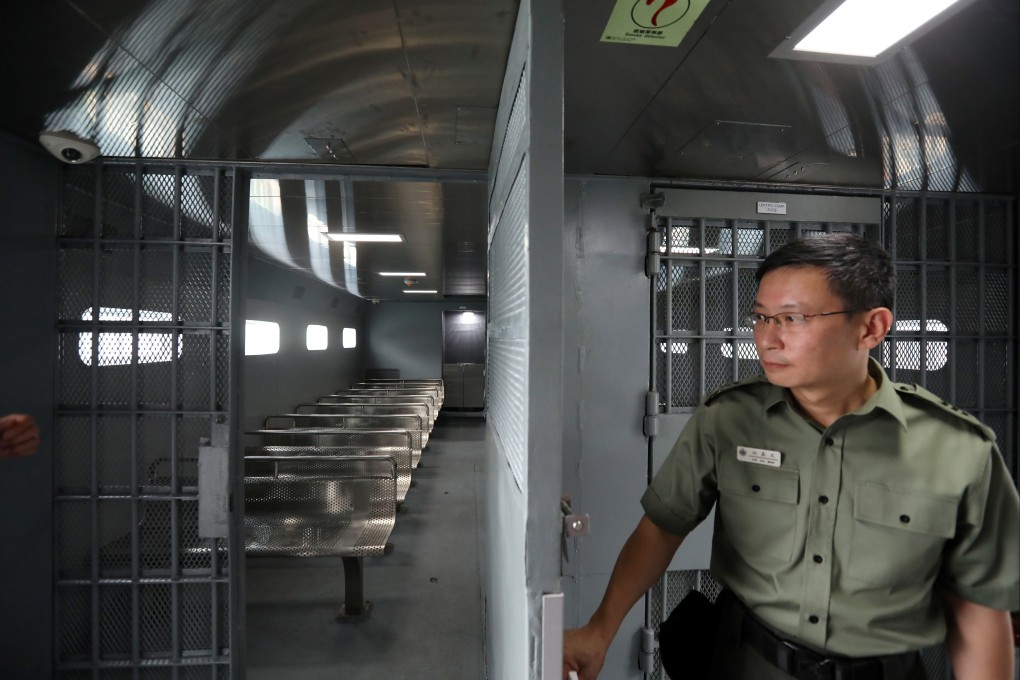A prison staff unveils the interior of the new Seaward boat to carry inmates. The correctional services department said it had 11 per cent of manpower unfilled. Photo: Nora Tam