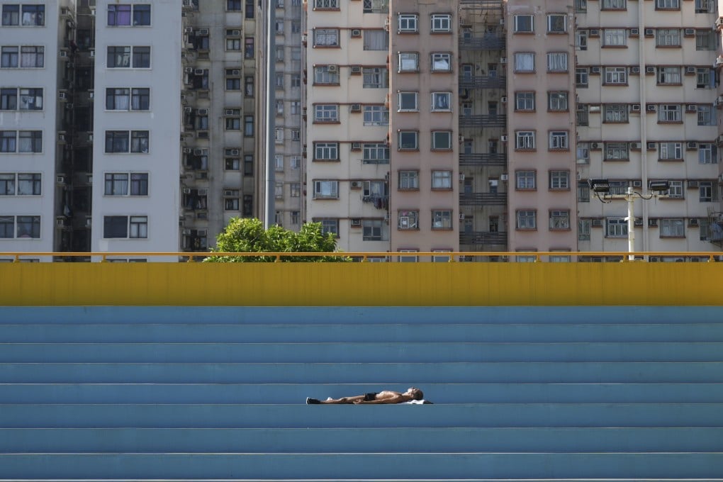 A man sunbaths in Hong Kong’s To Kwa Wan Recreation Ground. As the world continues to recover from the coronavirus pandemic, the outlook for Hong Kong’s property sector remains cloudy. Photo: Sam Tsang