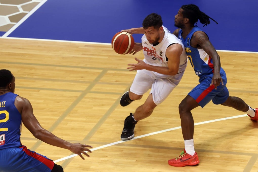 Duncan Reid takes on CJ Perez as Hong Kong (in white) face the Philippines in Tsuen Wan. Photo: Jonathan Wong