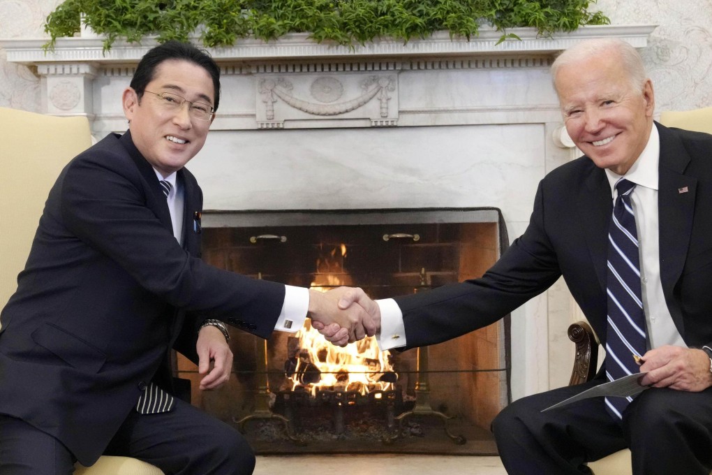 Japanese Prime Minister Fumio Kishida (left) and US President Joe Biden shake hands ahead of their talks at the White House in Washington on January 13, 2023. Photo: Kyodo