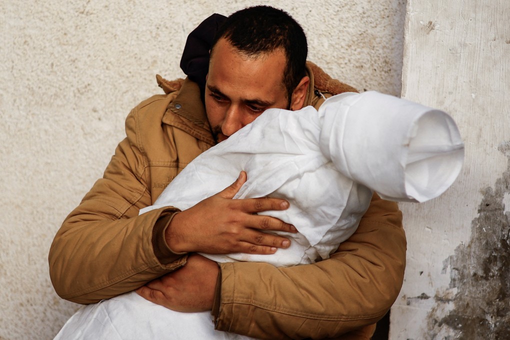 A Palestinian man carrying the body of his daughter who was killed in an Israeli strike in Rafah, in the southern Gaza Strip. Photo: Reuters