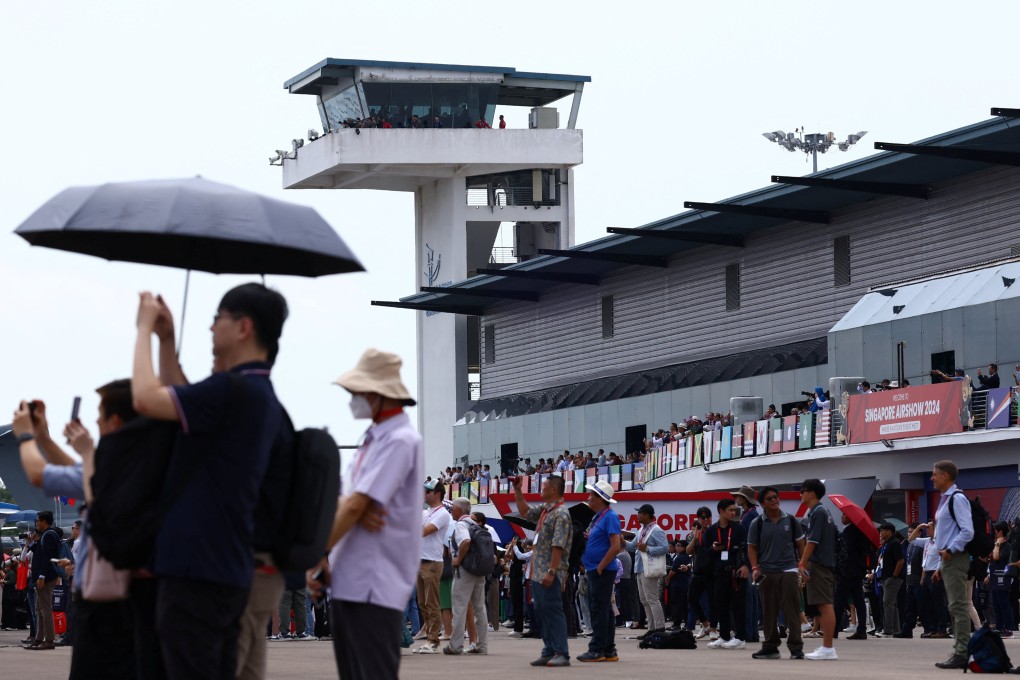 People watch an aerial display at the Singapore Airshow at Changi Exhibition Centre in Singapore on Thursday. Photo: Reuters
