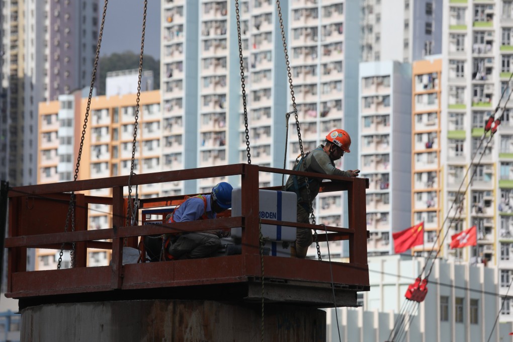 Construction workers at a public housing site in Cheung Sha Wan. Hong Kong aims to build all 30,000 temporary homes by 2027. Photo: Xiaomei Chen