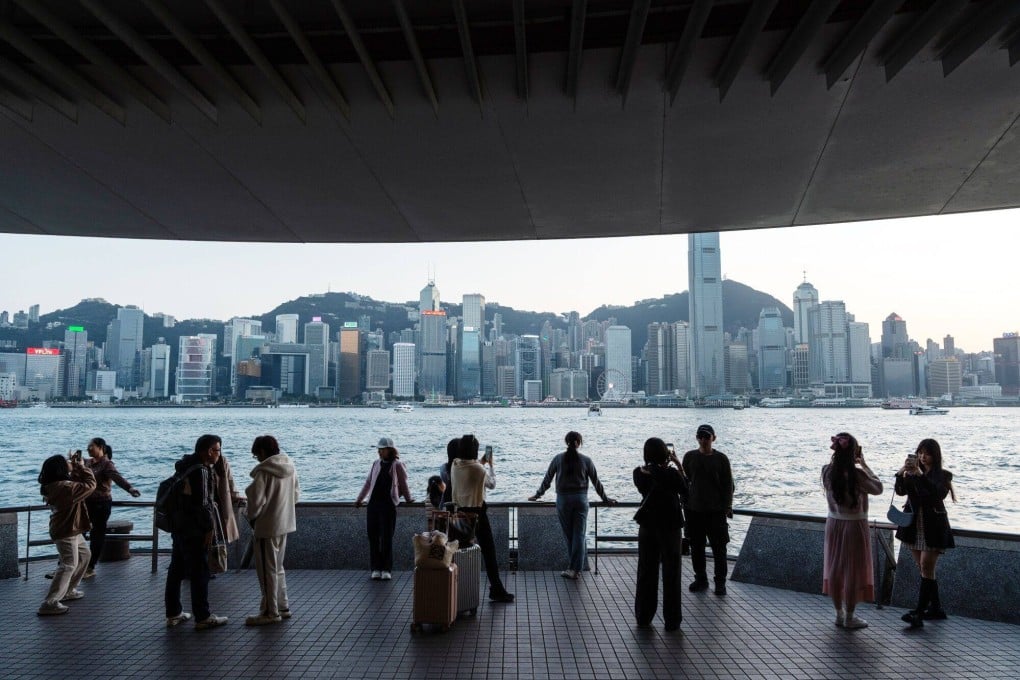Tourists along the Tsim Sha Tsui promenade during the Lunar New Year holiday in Hong Kong on Febryart 12. Predictions of the death of Hong Kong have surfaced from time and time and proven wrong each time. Photo: Bloomberg