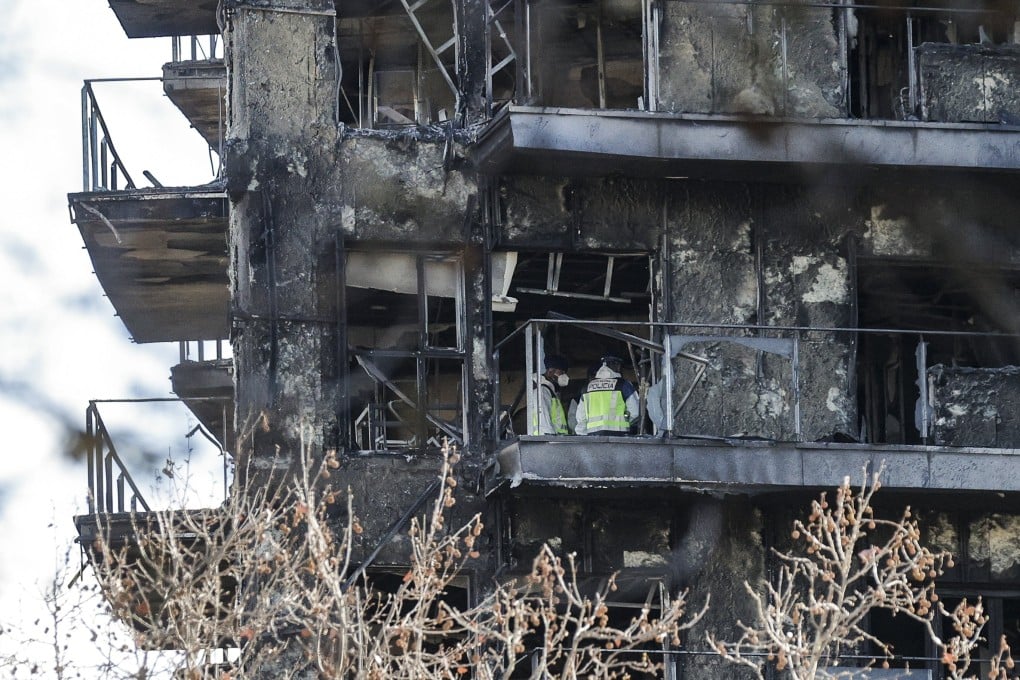 Several CSU policemen inspect one of the flats in one of the affected condominiums two days after a fire ripped through two residential blocks in Valencia. Photo: EPA-EFE