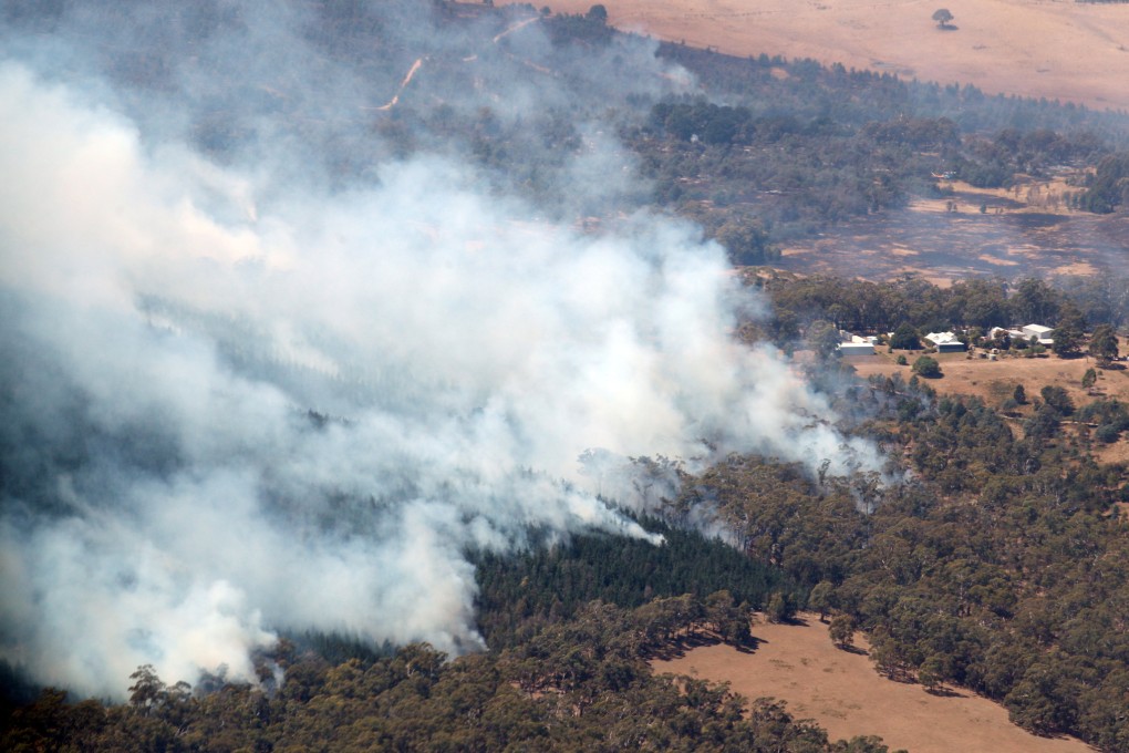 Smoke from bushfires rises north of Beaufort, near Ballarat in Victoria, Australia, on Saturday. Photo: AAP/Pool/via Reuters