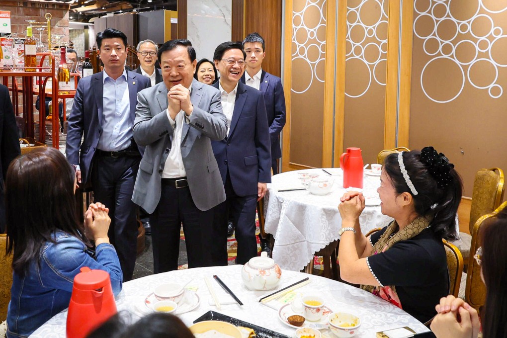 Top Beijing official Xia Baolong (third left) and city leader John Lee Ka-chiu (to the right of Xia) visit a teahouse on Saturday. Photo: SCMP