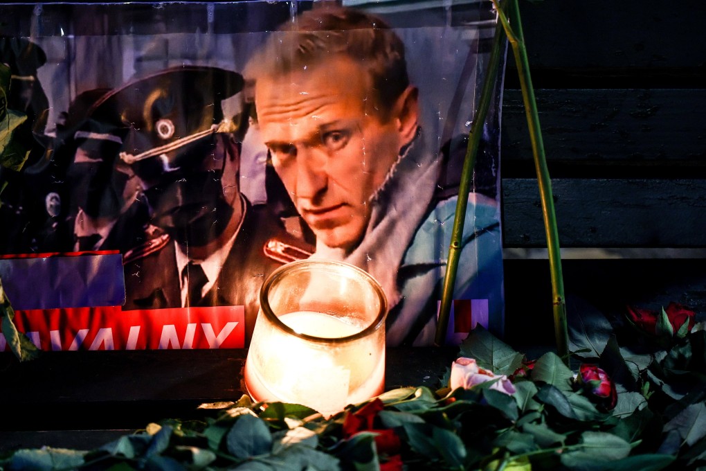 A portrait of late Russian opposition leader Alexei Navalny sits among floral tributes and a candle outside the Russian embassy in Berlin, Germany, on Saturday. Photo: EPA-EFE