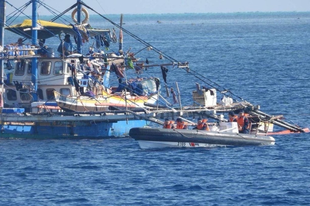 China Coast Guard personnel onboard a rigid-hulled inflatable boat (right) as they shadow a Philippine fishing boat (left) during a Filipino mission to bring supplies to fishermen near the Scarborough Shoal in the disputed South China Sea on February 22. Photo: Handout/Philippine Coast Guard/AFP