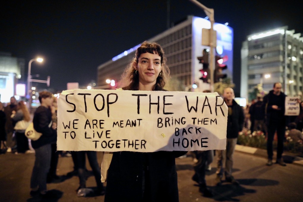 A woman holds a sign during a protest rally against the war in Gaza and calling for a ceasefire, in Tel Aviv, Israel, on Saturday. Photo: Xinhua