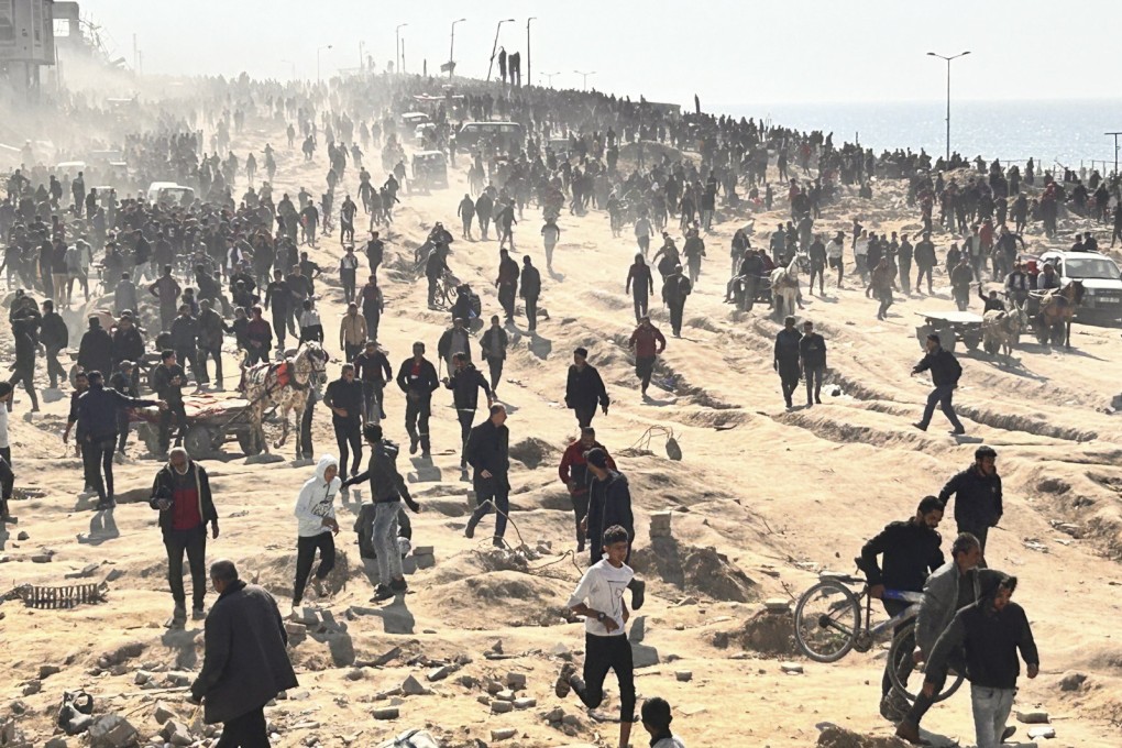 Palestinians wait for humanitarian aid on a beachfront in Gaza City, Gaza Strip, on Sunday. Photo: AP