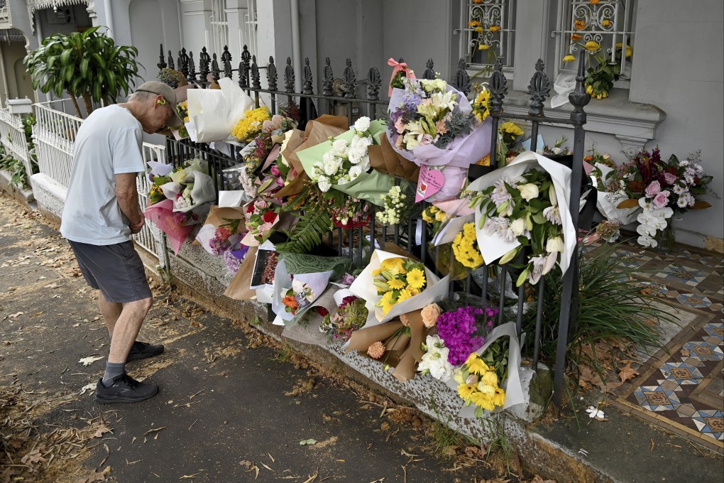 A man looks at floral tributes in Sydney at the Paddington residence of Jesse Baird, who police believe may have been murdered. Photo: AP